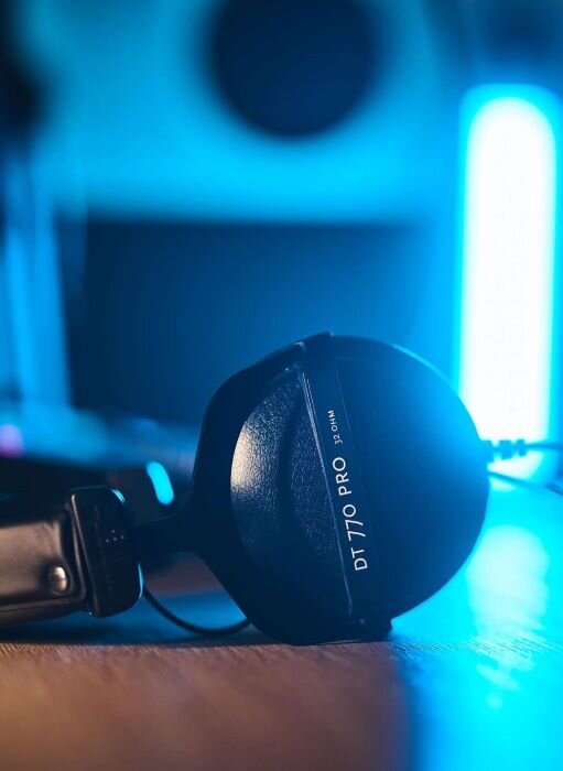Beyerdynamic DT770 Pro headphones on desk in podcast studio. | © Plug The Jack