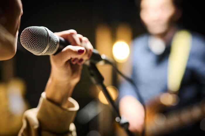 Singer at the microphone during a rehearsal